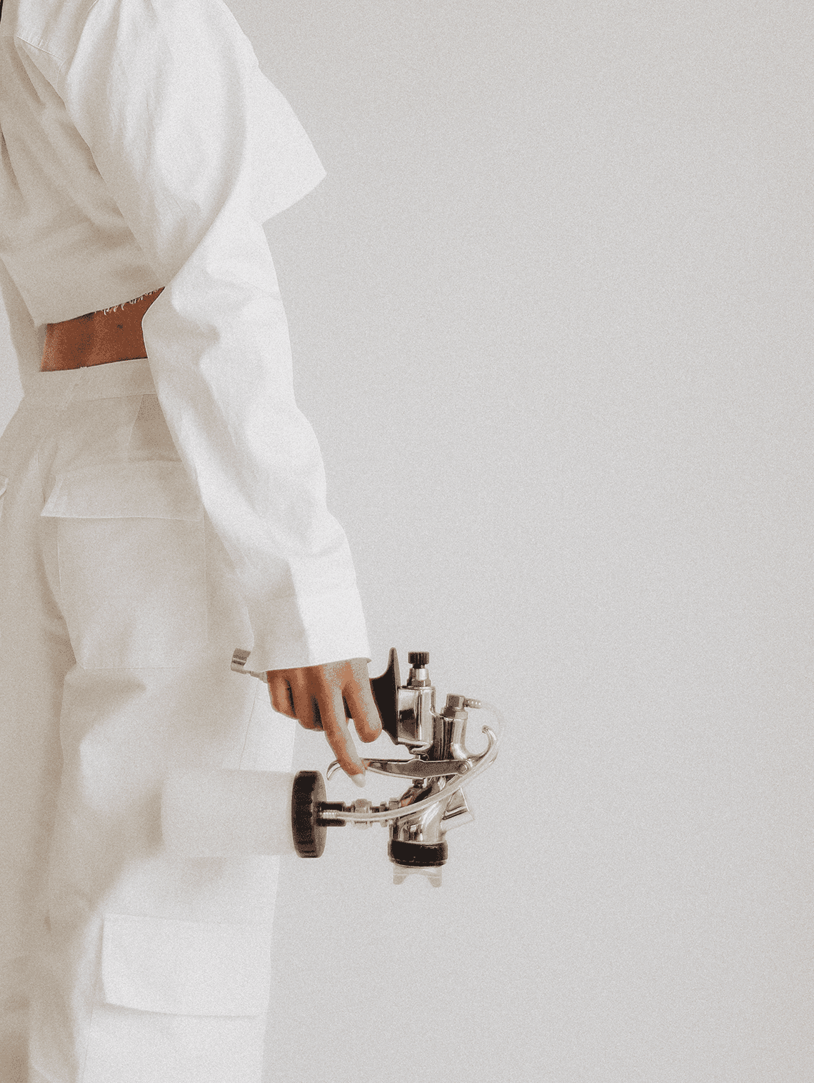 Spray tan artist holding a spray gun